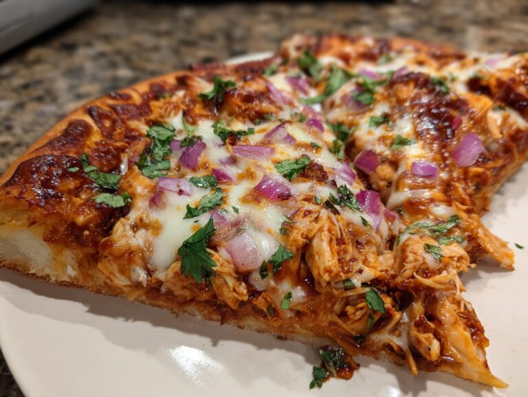 A slice of BBQ chicken pizza topped with red onions, cilantro, and melted cheese.
