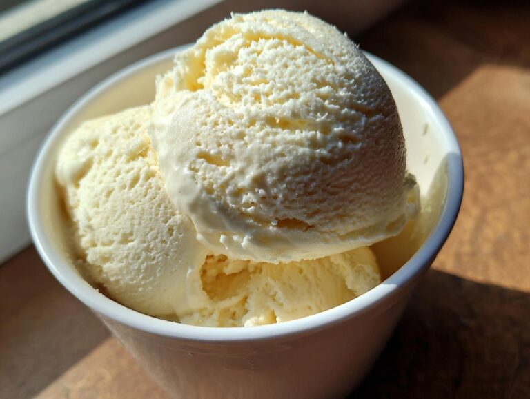 Close-up of no-churn vanilla ice cream with condensed milk in a white bowl, showcasing its creamy texture.