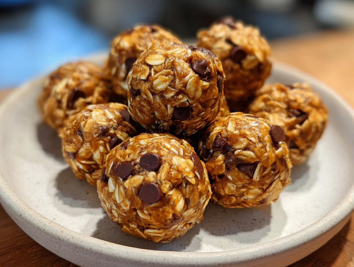 A close-up of peanut butter oatmeal energy bites with chocolate chips on a white plate.