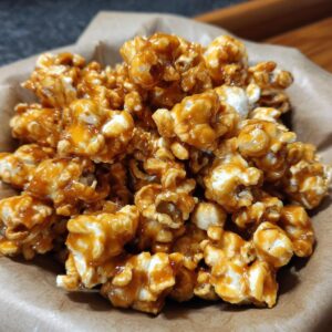 A close-up shot of a bowl filled with crunchy homemade caramel popcorn.