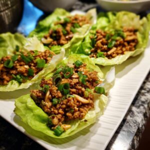 Close-up of delicious Chicken Lettuce Wraps Copycat PF Chang's, garnished with chopped green onions.