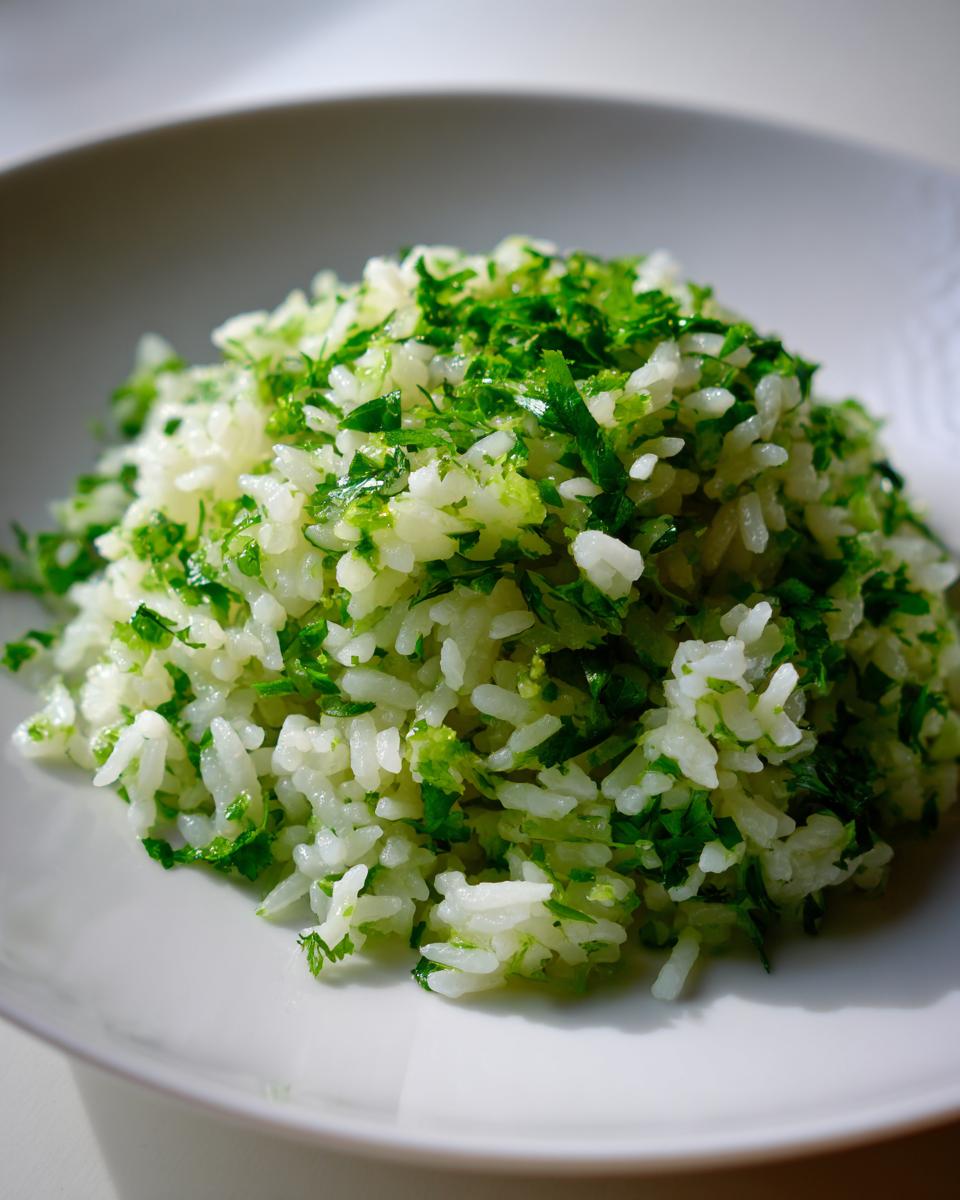A mound of fluffy cilantro lime rice topped generously with bright green chopped cilantro.