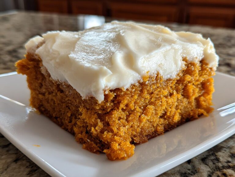 A close-up, featured image of one square pumpkin bar with thick, creamy pumpkin bars with cream cheese frosting.